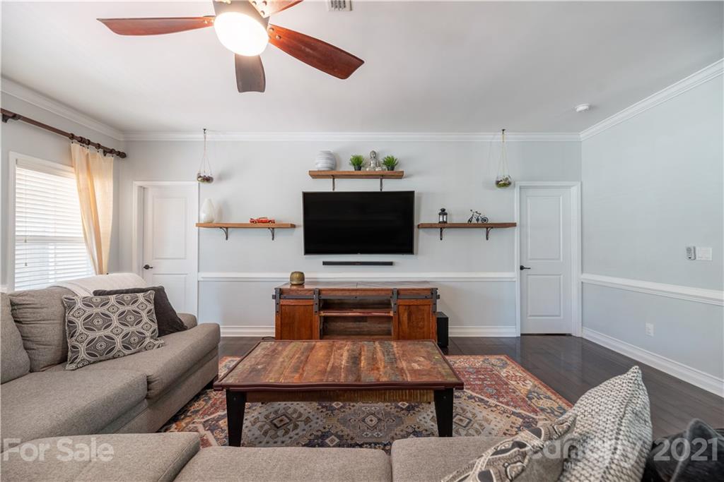 8049 Bryson Road, Unit 117 Indian Land, SC 29707 - Photo 23 of 40 a living room with furniture and a flat screen tv