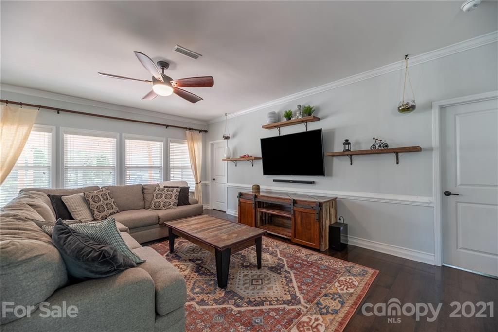 8049 Bryson Road, Unit 117 Indian Land, SC 29707 - Photo 24 of 40 a living room with furniture and a flat screen tv