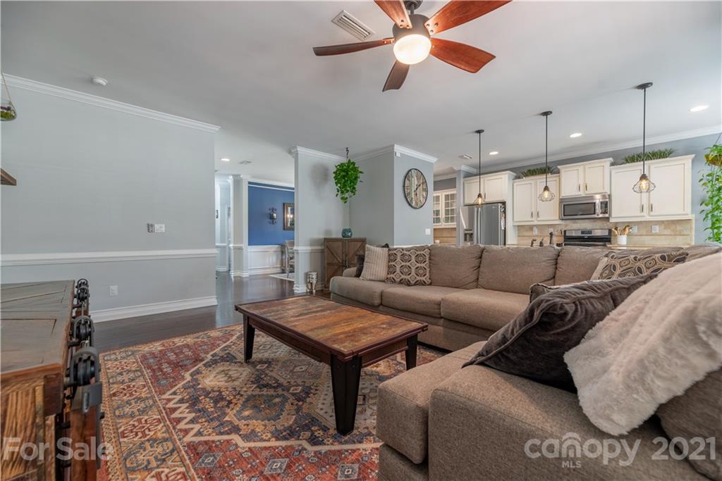 8049 Bryson Road, Unit 117 Indian Land, SC 29707 - Photo 25 of 40 a living room with furniture and a chandelier