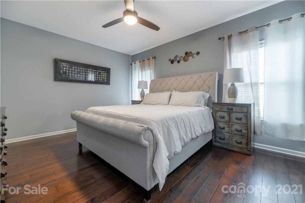 8049 Bryson Road, Unit 117 Indian Land, SC 29707 - Photo 26 of 40 a bedroom with a bed and wooden floor