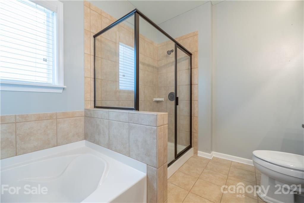 8049 Bryson Road, Unit 117 Indian Land, SC 29707 - Photo 31 of 40 a bathroom with a bathtub and a shower