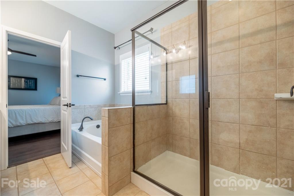 8049 Bryson Road, Unit 117 Indian Land, SC 29707 - Photo 33 of 40 a bathroom with a bathtub and a shower