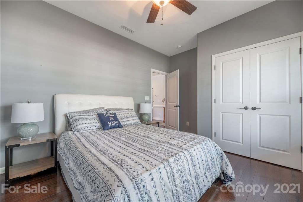 8049 Bryson Road, Unit 117 Indian Land, SC 29707 - Photo 9 of 40 a bedroom with a bed and a painting on the wall