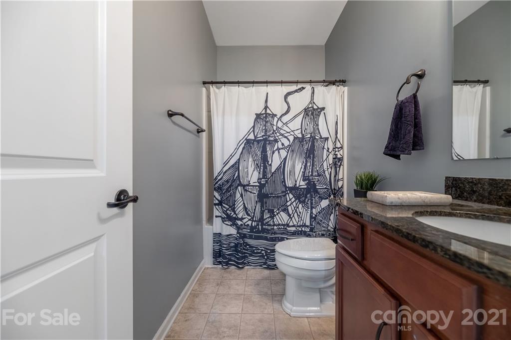 8049 Bryson Road, Unit 117 Indian Land, SC 29707 - Photo 10 of 40 a bathroom with a granite countertop sink toilet and shower