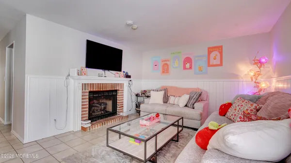 a living room with furniture a flat screen tv and a fireplace