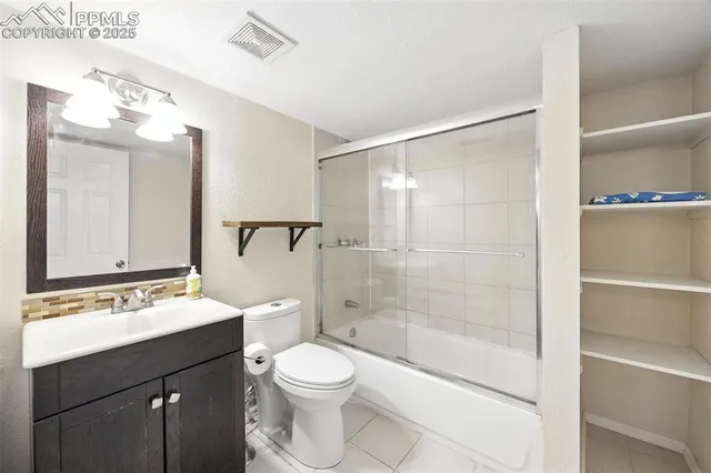 a bathroom with a bathtub shower sink mirror and toilet