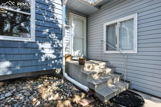 a backyard of a house with outdoor seating