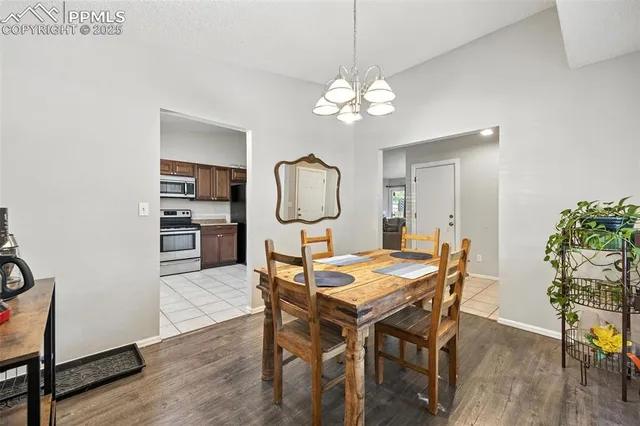 a view of a dining room with furniture wooden floor and chandelier