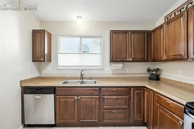 a kitchen with stainless steel appliances granite countertop a sink dishwasher a stove a microwave oven and cabinets with wooden floor