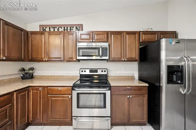 a kitchen with a refrigerator stove and microwave