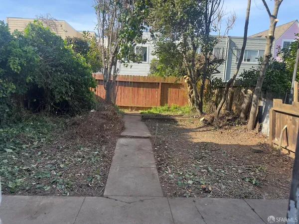 a view of a backyard with large trees
