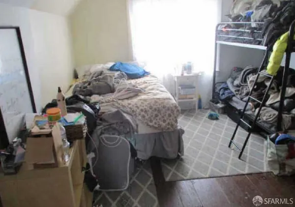a bed sitting in a room next to a window