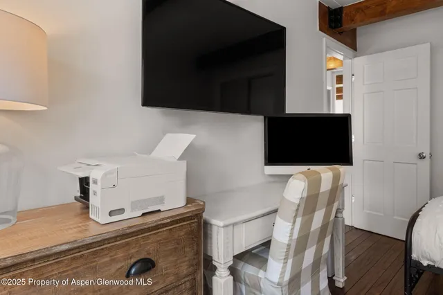 a living room with a flat screen tv and a fireplace