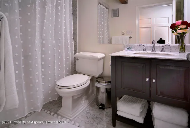 a bathroom with a sink toilet and a mirror