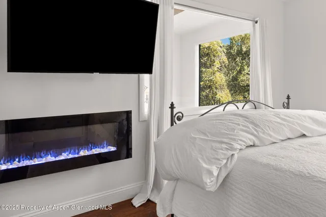 a bed sitting in a bedroom next to a window