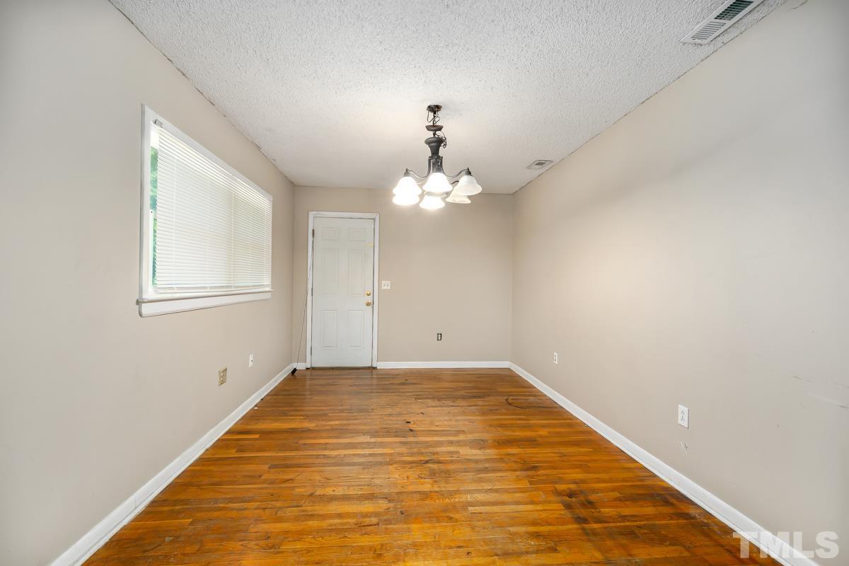 3003 Cheek Road Durham, NC 27704 - Photo 14 of 24 a view of a big room with a chandelier fan and windows