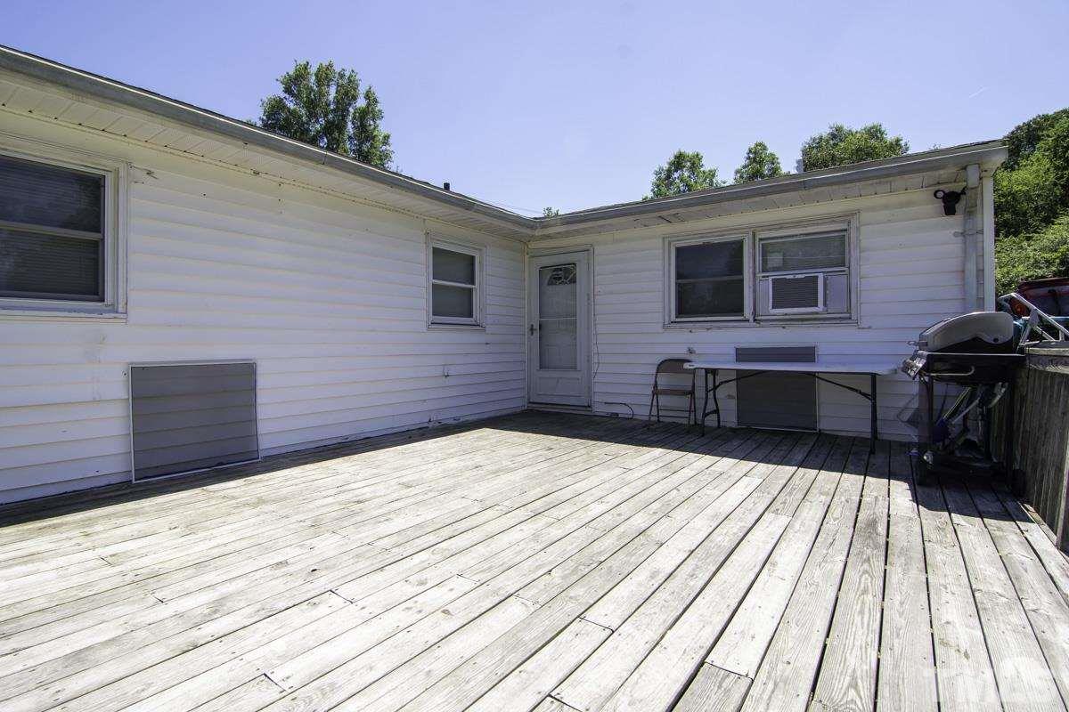 3003 Cheek Road Durham, NC 27704 - Photo 4 of 24 a view of backyard with a wooden deck and furniture