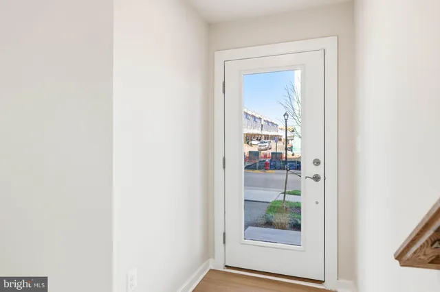 a view of a big room with wooden floor and stairs