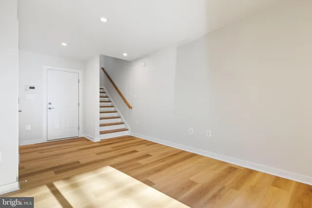 a bathroom with a sink a toilet a mirror and shower
