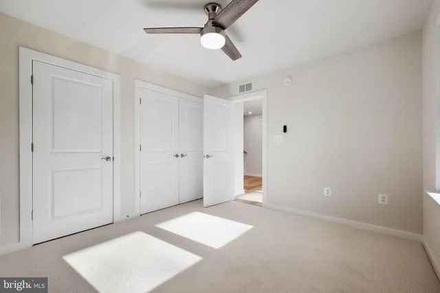 a view of a hallway with wooden floor and entryway