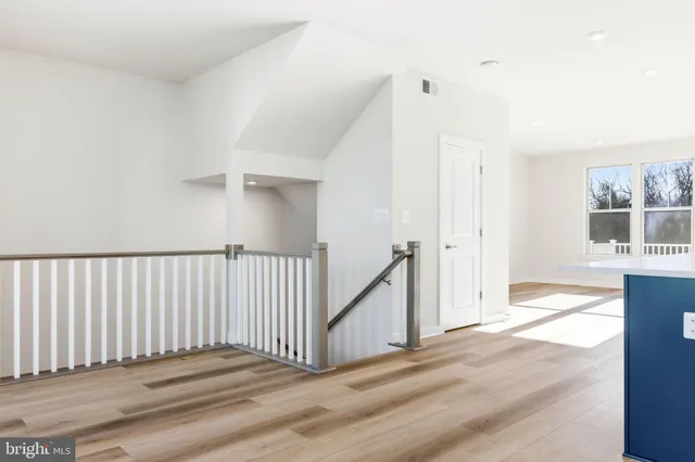 an empty room with a window and a ceiling fan