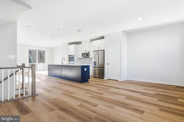 a bathroom with a granite countertop sink a toilet and a bathtub