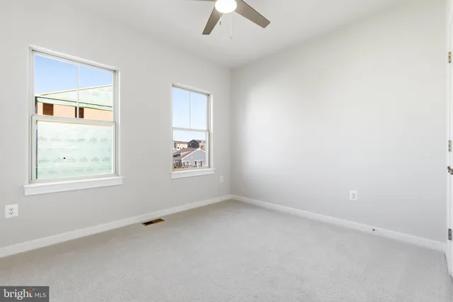 a white toilet sitting next to a shower