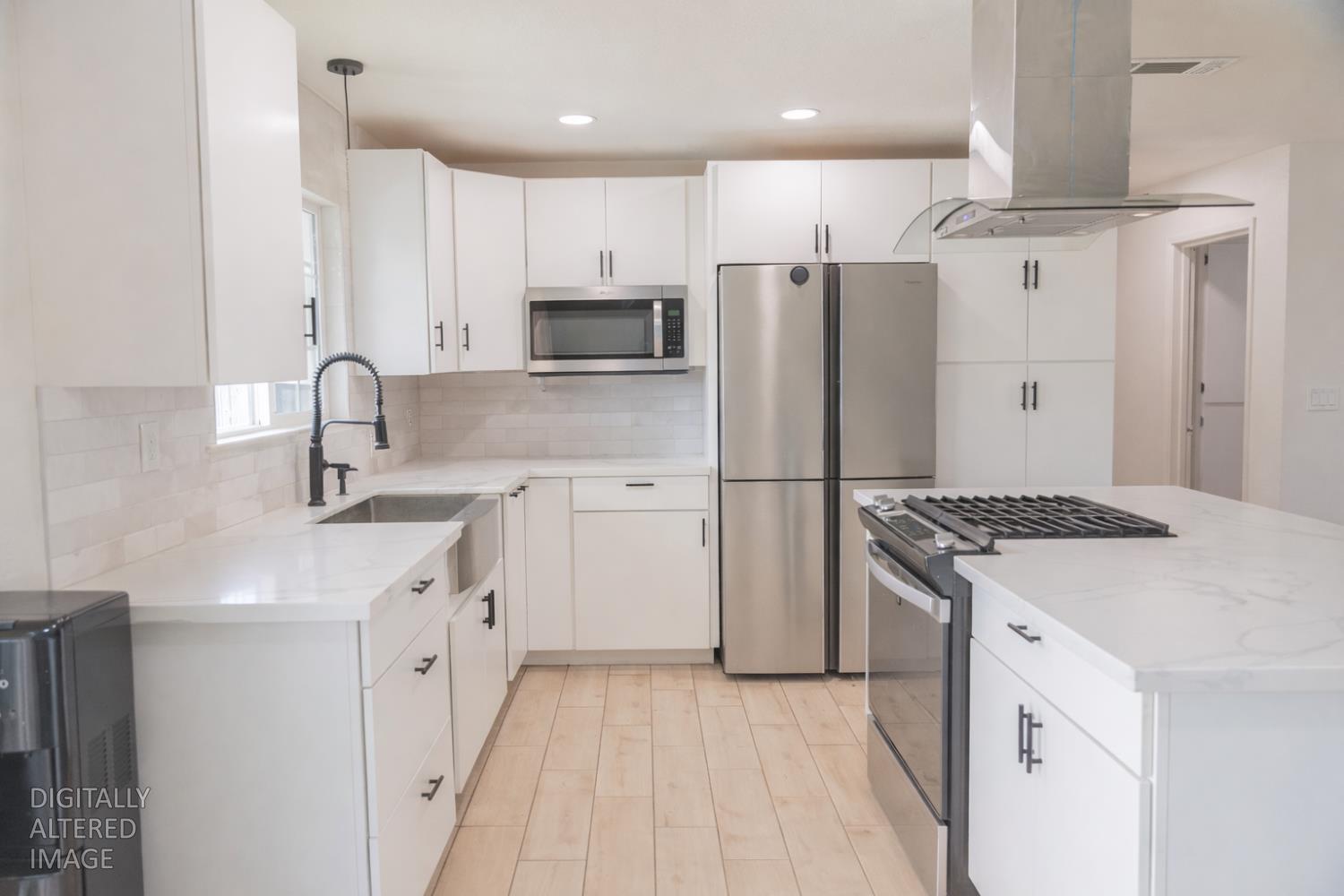 1612 Larry Street Olivehurst, CA 95961 - Photo 6 of 27 a kitchen with white cabinets and stainless steel appliances