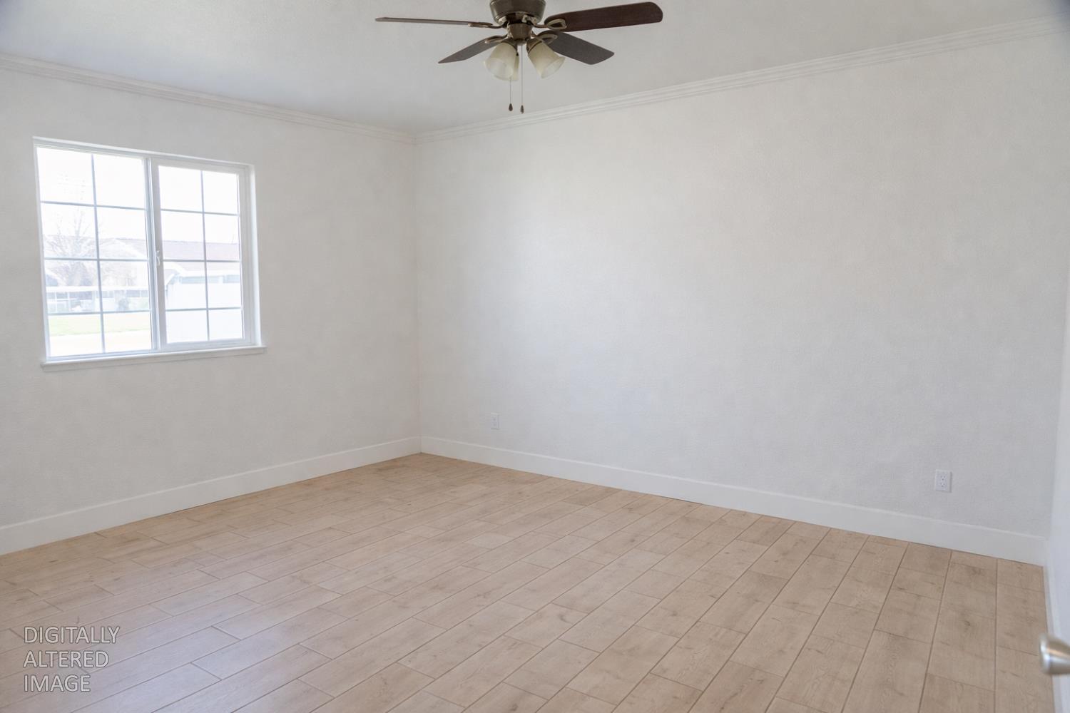 1612 Larry Street Olivehurst, CA 95961 - Photo 9 of 27 an empty room with a window and a ceiling fan