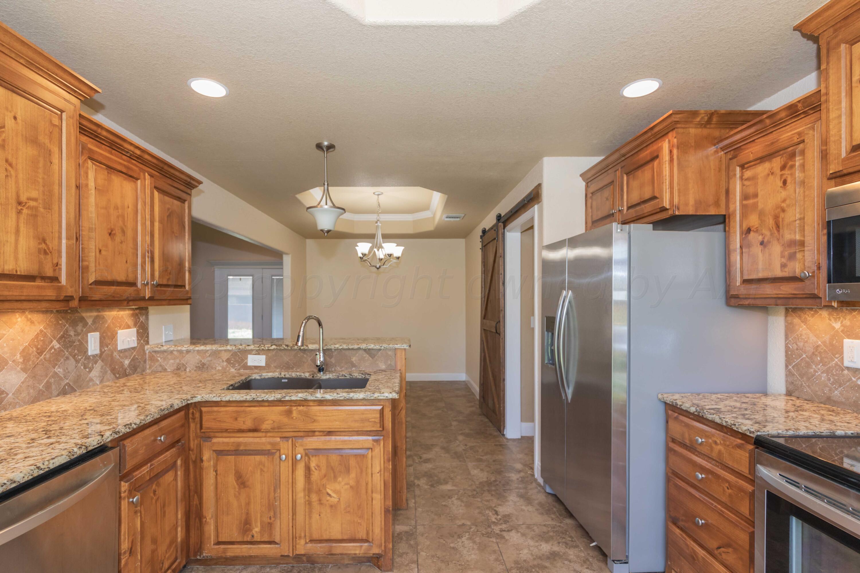 3904 Arden Road Amarillo, TX 79118 - Photo 12 of 45 a kitchen with stainless steel appliances granite countertop a refrigerator and a sink