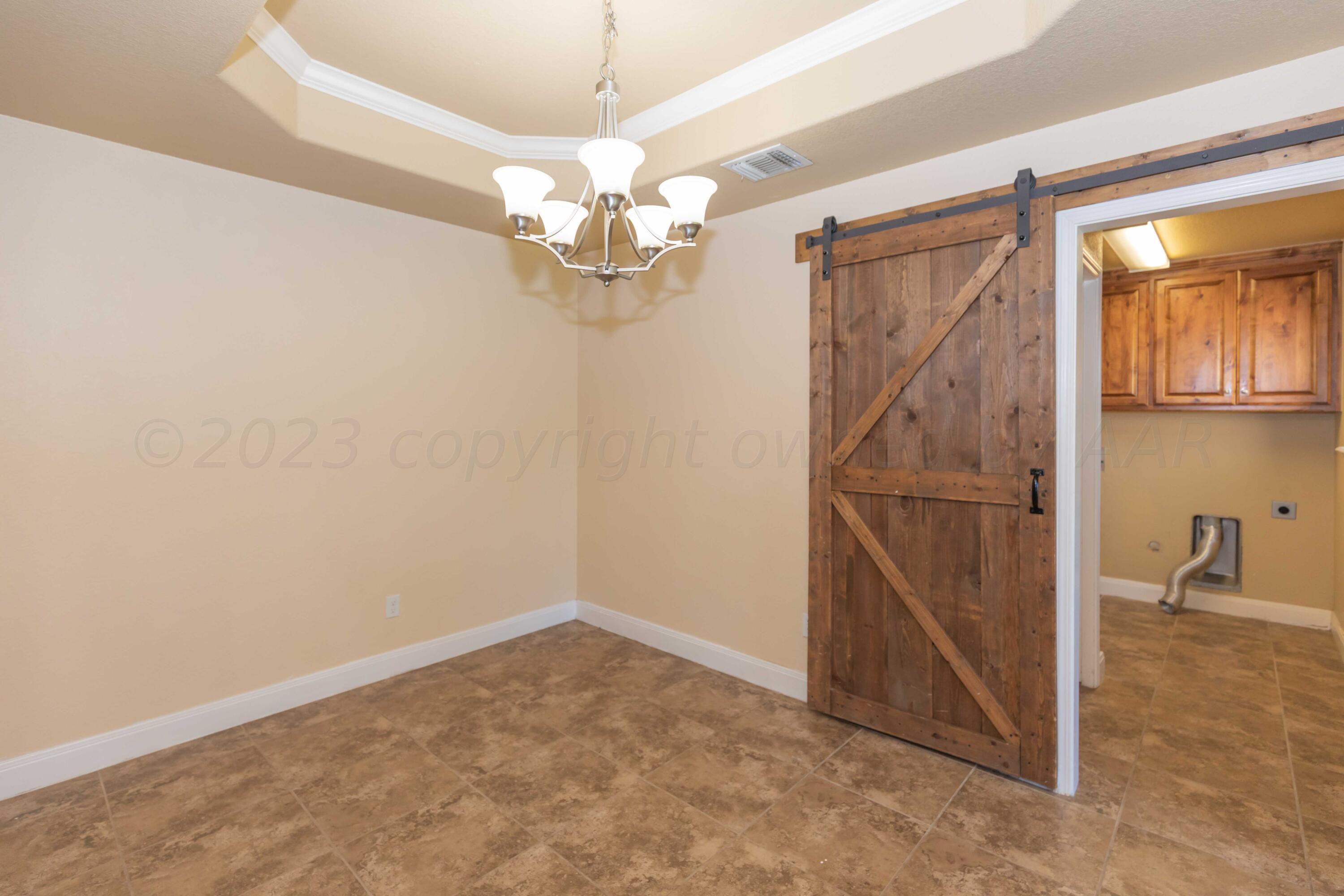 3904 Arden Road Amarillo, TX 79118 - Photo 15 of 45 an empty room with chandelier fan and windows