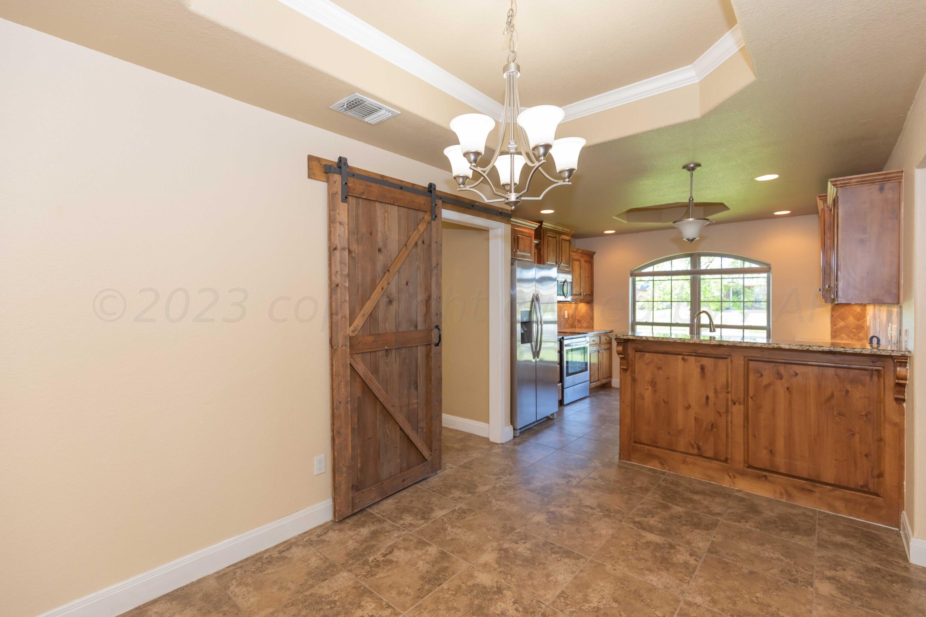 3904 Arden Road Amarillo, TX 79118 - Photo 16 of 45 a view of a livingroom with a chandelier furniture and windows