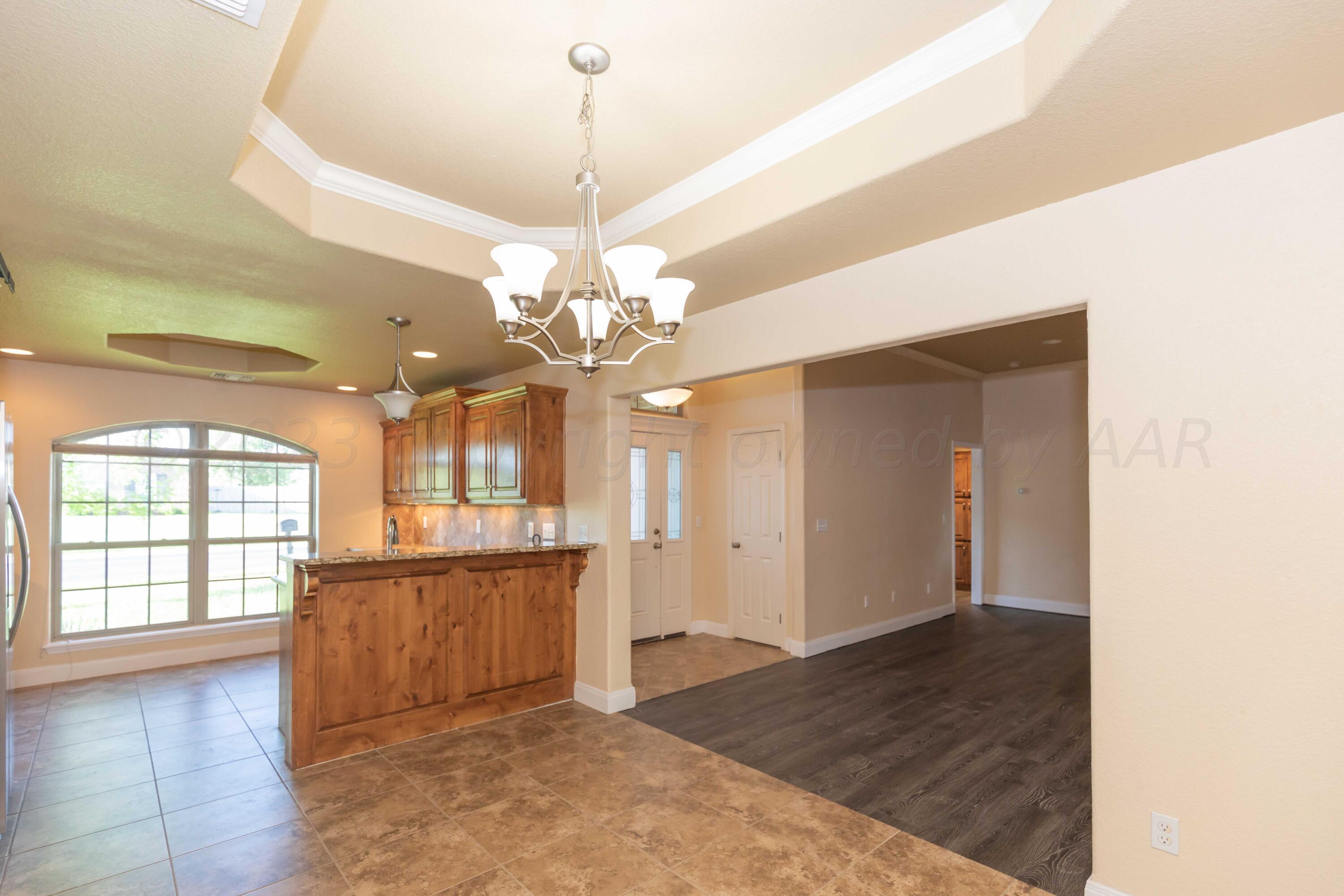 3904 Arden Road Amarillo, TX 79118 - Photo 17 of 45 a view of a livingroom with a chandelier fan and windows