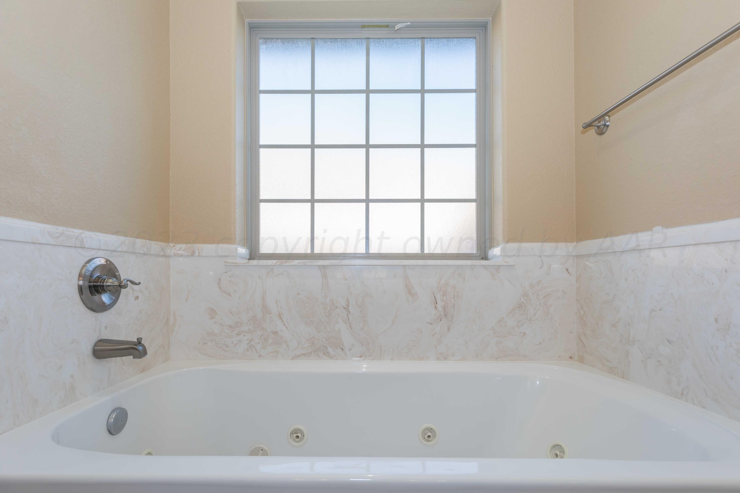 3904 Arden Road Amarillo, TX 79118 - Photo 27 of 45 a bathroom with a bathtub