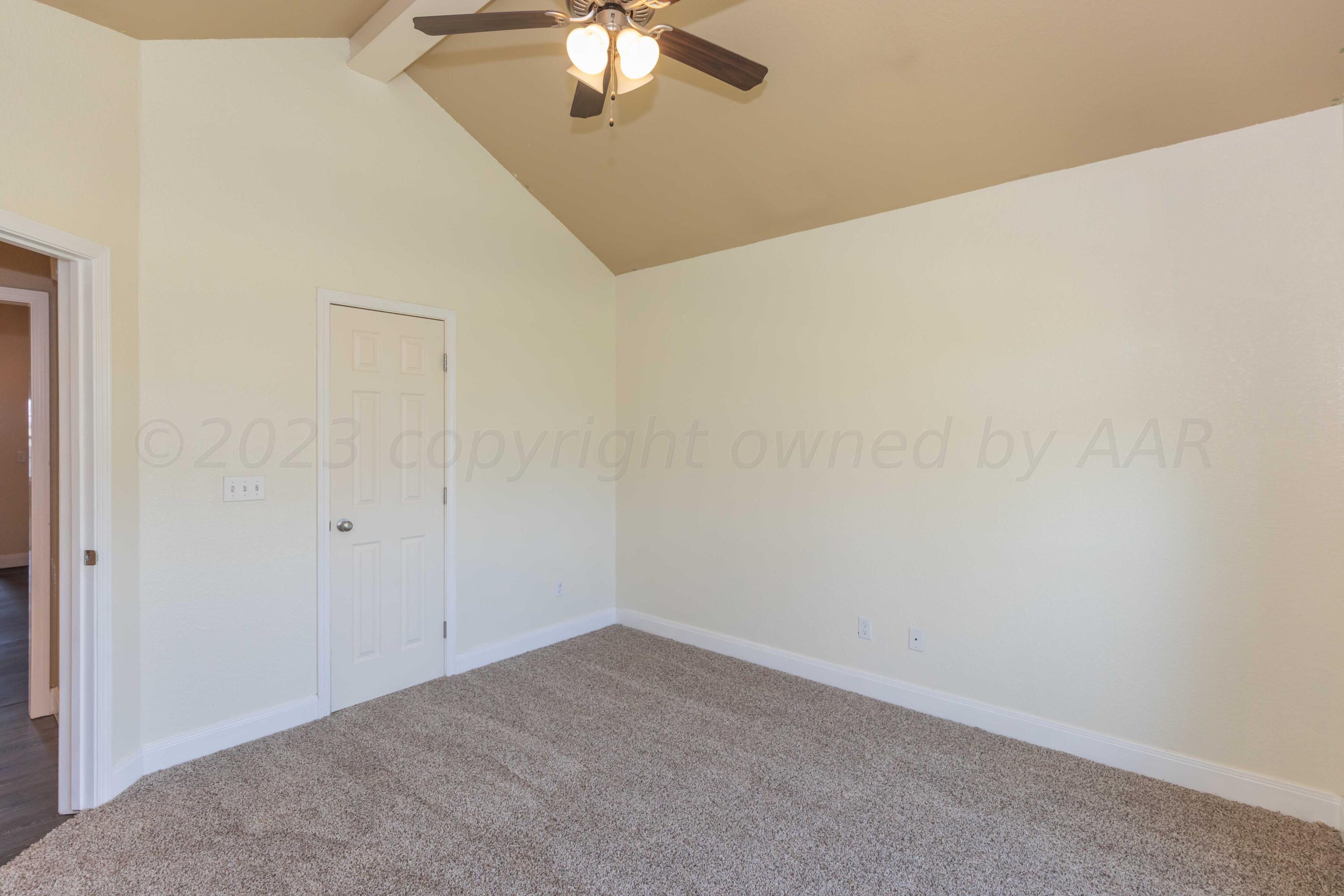 3904 Arden Road Amarillo, TX 79118 - Photo 31 of 45 an empty room with a chandelier fan