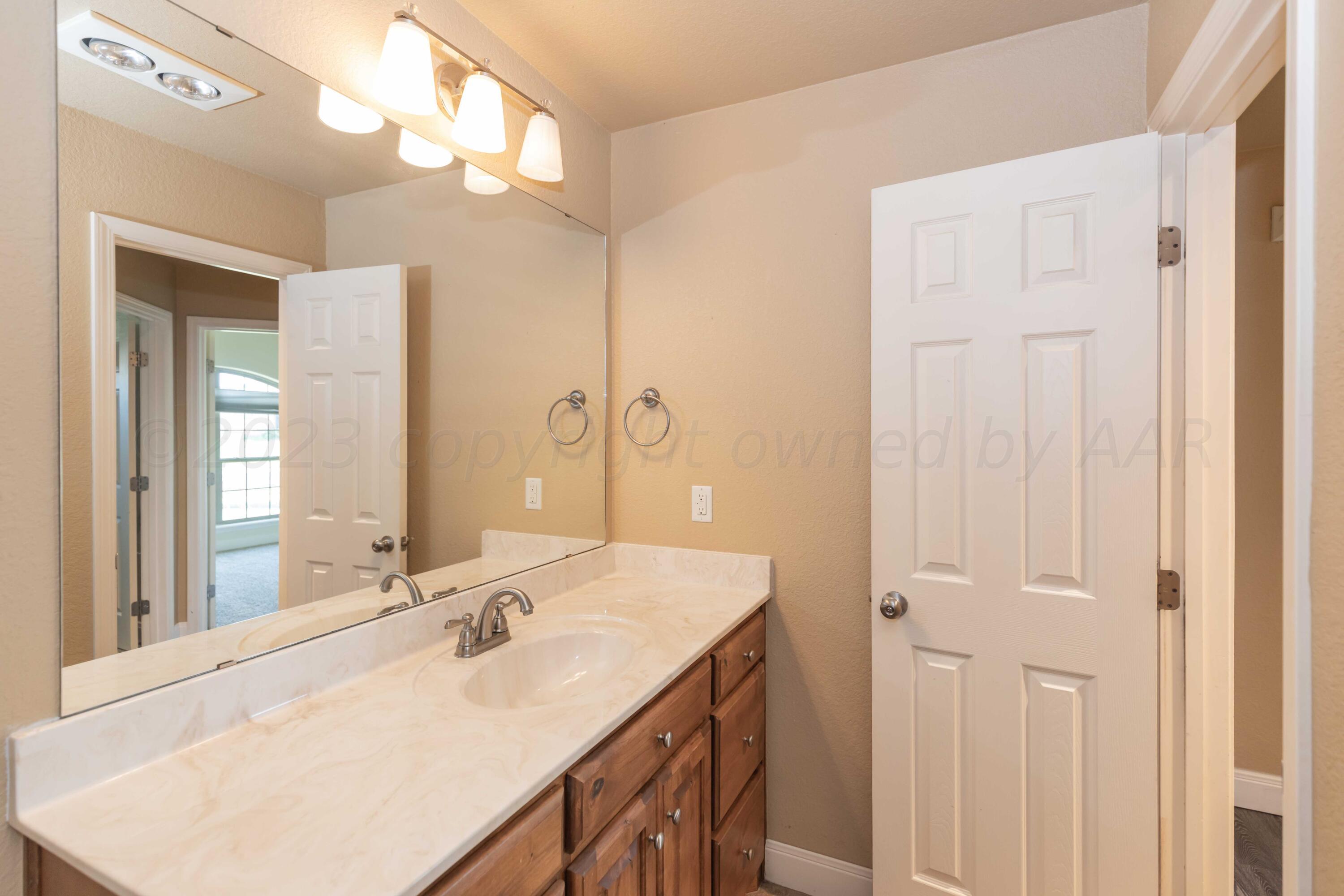 3904 Arden Road Amarillo, TX 79118 - Photo 34 of 45 a bathroom with a sink double vanity and a mirror