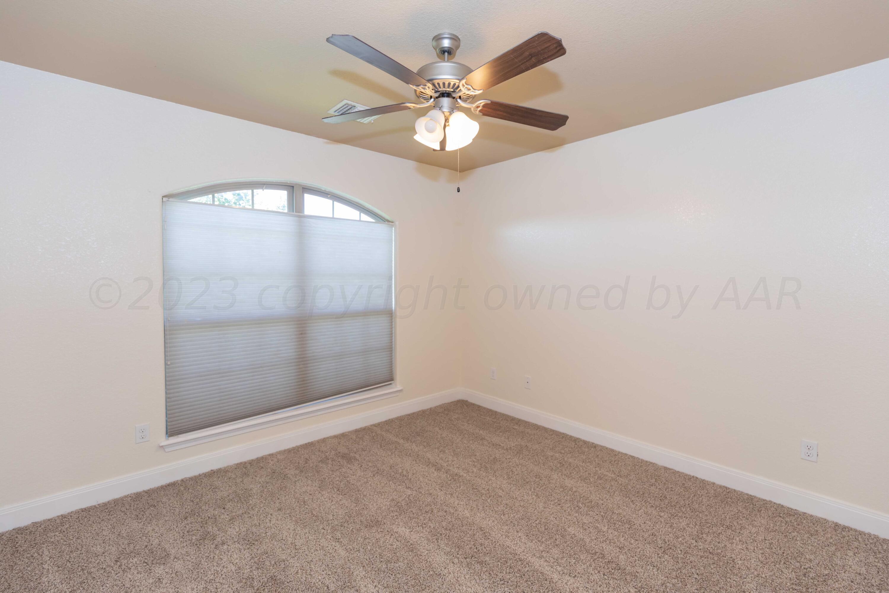 3904 Arden Road Amarillo, TX 79118 - Photo 36 of 45 an empty room with windows and ceiling fan