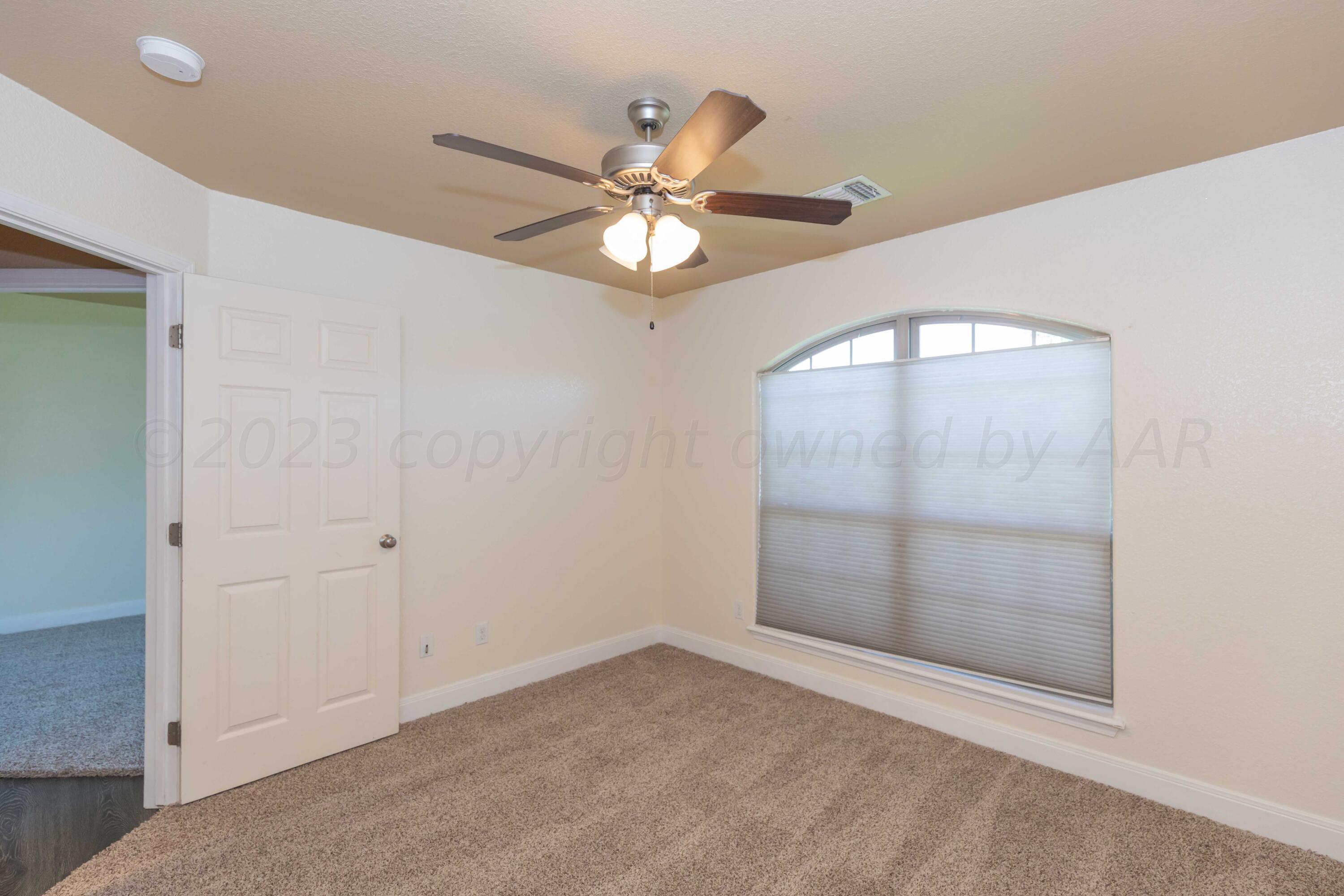 3904 Arden Road Amarillo, TX 79118 - Photo 39 of 45 an empty room with closet and a chandelier fan