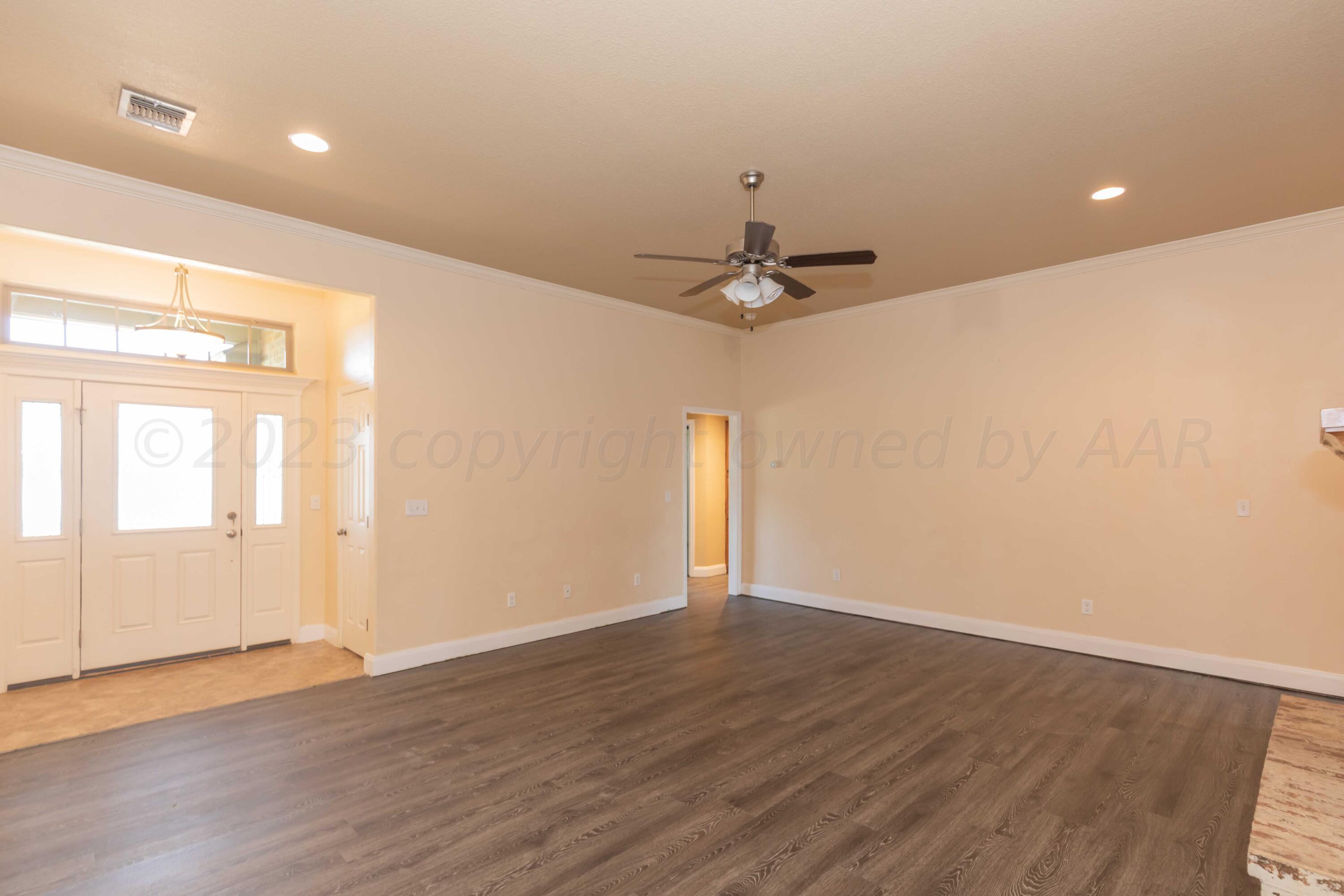 3904 Arden Road Amarillo, TX 79118 - Photo 6 of 45 a view of an empty room with wooden floor and a window