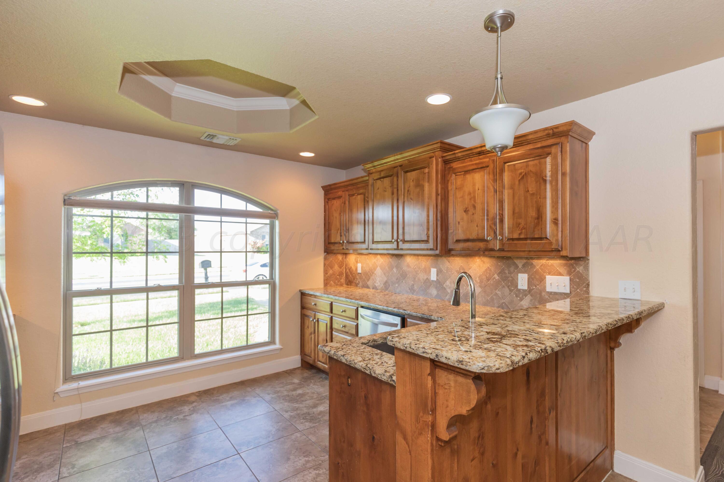3904 Arden Road Amarillo, TX 79118 - Photo 9 of 45 a kitchen with a sink and a window