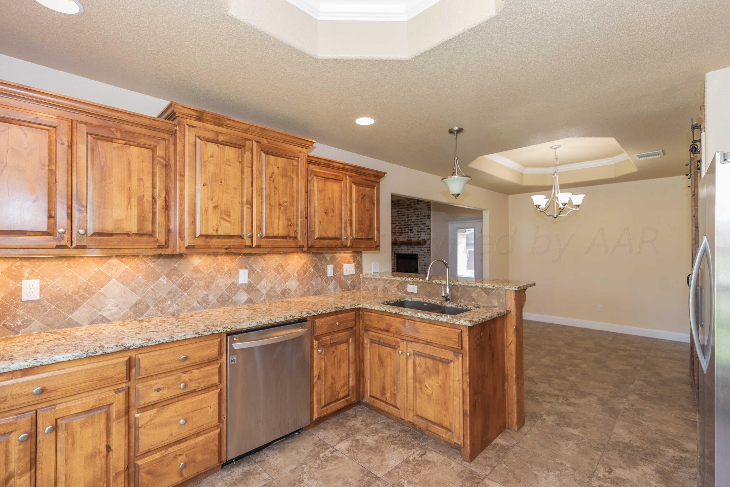 3904 Arden Road Amarillo, TX 79118 - Photo 10 of 45 a kitchen with a sink window and cabinets