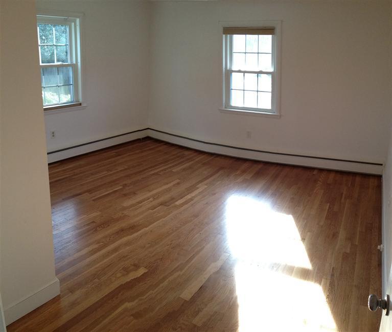 18 Great Marsh Road Centerville, MA 02632 - Photo 13 of 28 an empty room with wooden floor and windows
