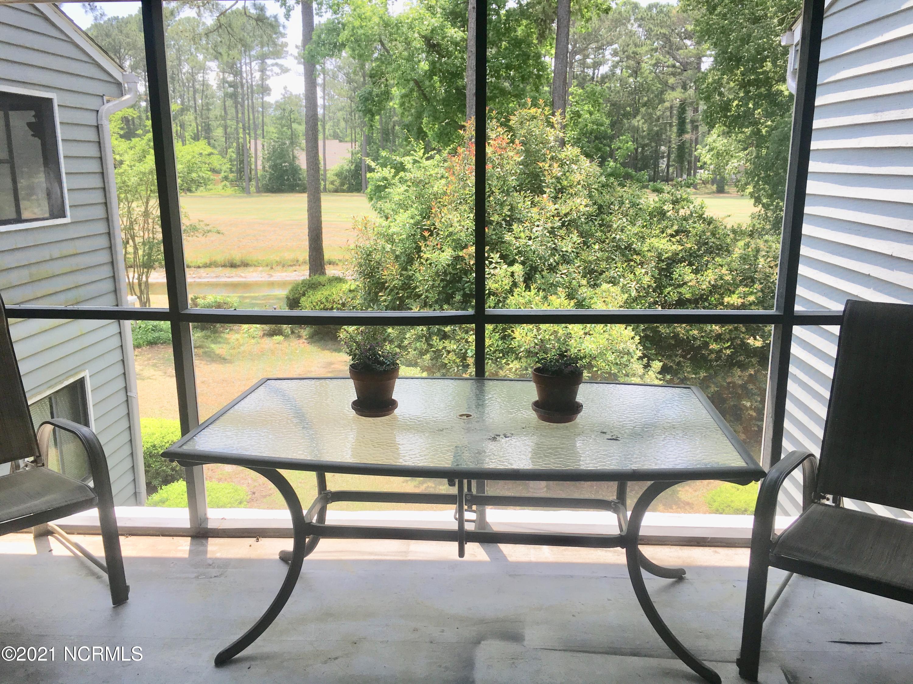 718 Azalea Drive, Unit 458 Hampstead, NC 28443 - Photo 13 of 14 Screened Porch w/Golf Course views!