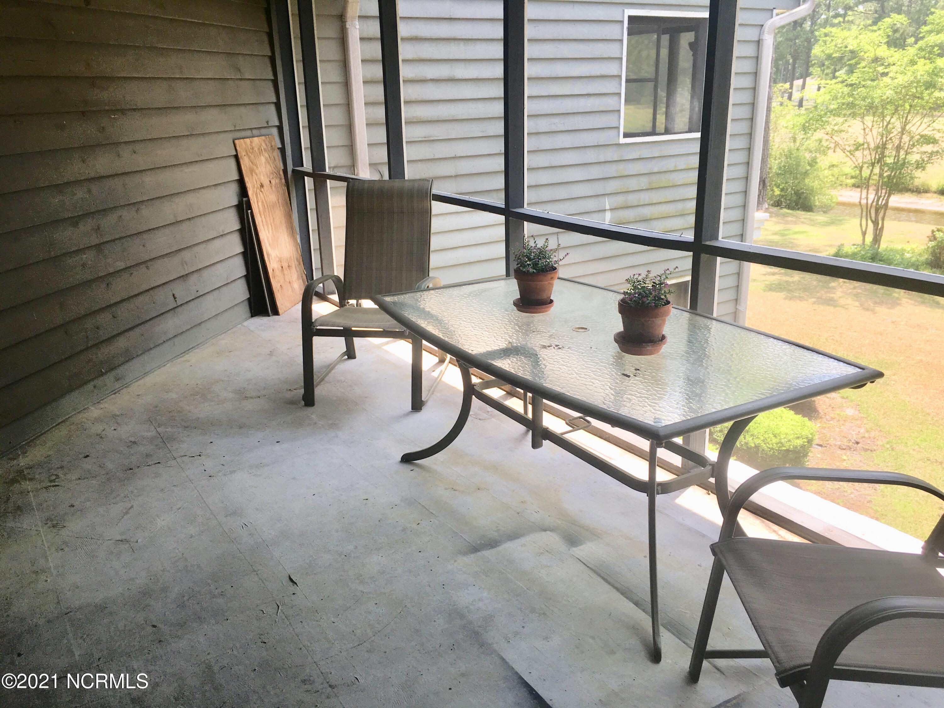 718 Azalea Drive, Unit 458 Hampstead, NC 28443 - Photo 14 of 14 Large screened porch