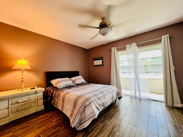 a bedroom with a bed and a large window