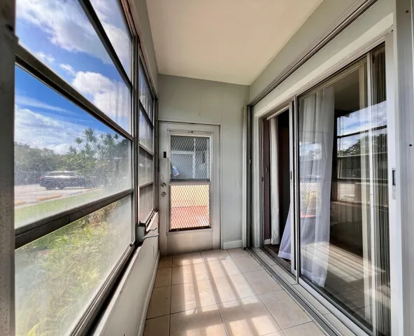 a view of an entryway with a floor to ceiling window