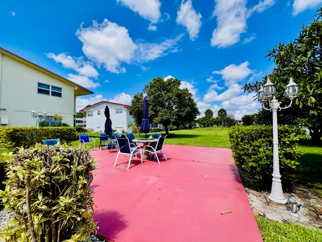 a view of a chairs and table in backyard
