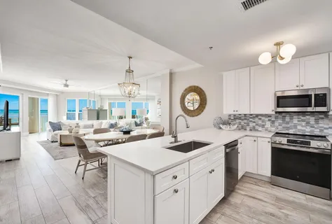 a kitchen with a sink stove and microwave