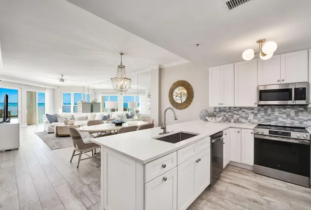 a kitchen with a sink stove and microwave