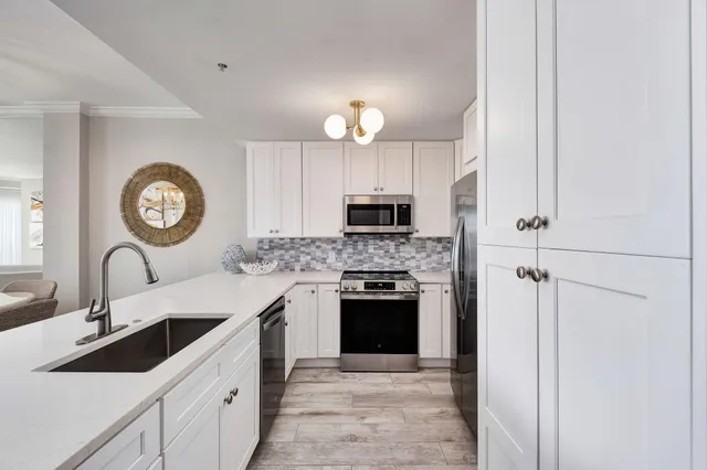 a kitchen with cabinets a sink and a stove top oven